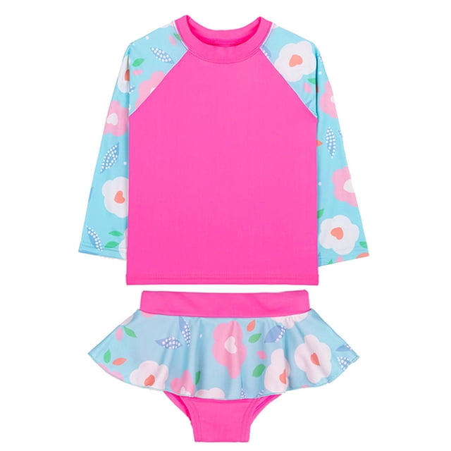Sunnyoo Toddler Girls 2 Piece Swimsuit Long Sleeve Rash Guard & Shorts Swimwear, Sizes 12M-5T. The set features a vibrant pink rash guard with floral-patterned blue sleeves and matching ruffled shorts in the same floral design. Crafted from lightweight, stretchy polyester with UPF 50+ sun protection, it ensures comfort and freedom of movement. Suitable for toddlers aged 12 months to 5 years, this swimwear is perfect for beach trips, pool days, and summer adventures.