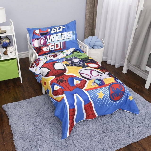 Marvel Spidey & Friends 3-Piece Toddler Bedding Set on a white toddler bed featuring a blue reversible comforter with large Spider-Man and friends graphics, a pillowcase with 'GO WEBS GO!' text, and a fitted sheet sized for a standard crib mattress, set on a gray rug over hardwood floors in a toddler room.