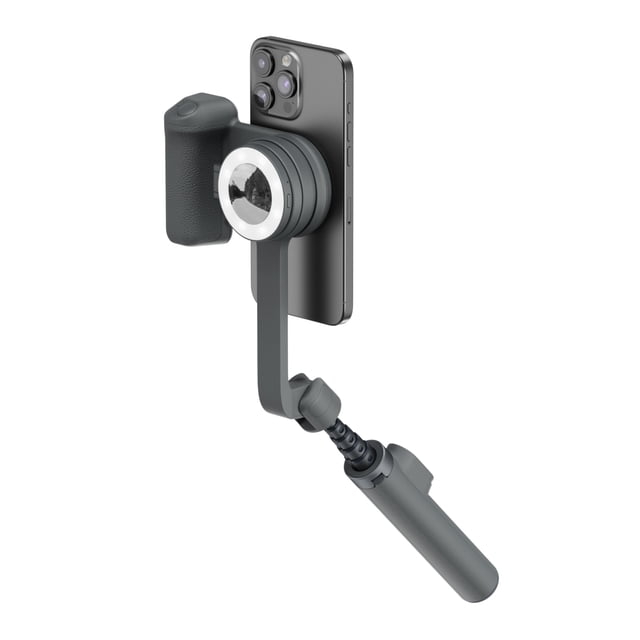 ShiftCam SnapTravel Kit Essential Midnight with a black smartphone attached to a magnetic camera grip featuring an ergonomic textured handle, adjustable arm, and compact cylindrical light, offering portable, hands-free stabilization and lighting for mobile content creators.
