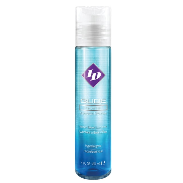 ID Glide Natural Feel Water Based Personal Lubricant, 1 oz bottle. The clear bottle features a blue gradient design with a purple diamond-shaped logo and white text. This water-based lubricant is hypoallergenic, easy to rinse off, and suitable for men, women, and couples. Ideal for intimate moments or use with toys.