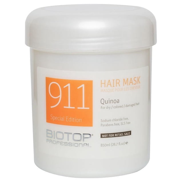 Biotop - 911 Special Edition Masque Capillaire au Quinoa dans un Contenant de 850 ml (28,7 fl oz). le Pot Présente un Corps Blanc avec une Étiquette orange Affichant le Nom du Produit et les Détails. Conçu pour les Cheveux Secs, Colorés Ou Abîmés, Il Est Enrichi d'Extrait de Quinoa, d'Huile de macadamia, d'Huile d'Argan et de Vitamine E pour Restaurer l'Hydratation, l'Élasticité et la Brillance. la Formule Est Sans Parabènes, de Chlorure de sodium et