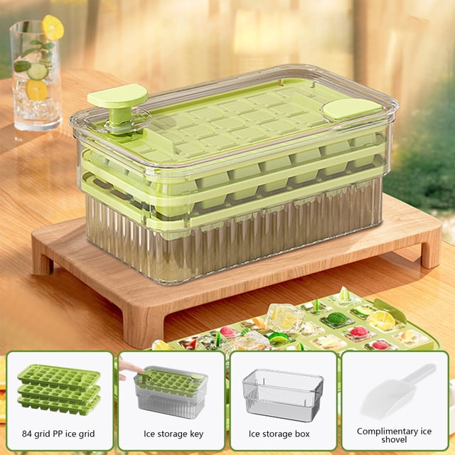 EGNMCR Kitchen Gadgets, Kitchen Accessories, Kitchen Utensils Easy Release Ice Cubes Tray With Lid And Bin 3 Pack Ice Cubes Trays For Freezer 84 Pcs Ice Trays For Whiskey Cocktail Tea Coffee. The image shows a green plastic ice cube tray set with a transparent lid and storage bin, placed on a wooden surface. The set includes three stackable trays, each with 84 compartments, a storage box, and a complimentary ice scoop. Ideal for making ice cubes for beverages like whiskey, cocktails, tea, and coffee. The lid prevents odor absorption, and the trays are designed for easy release.