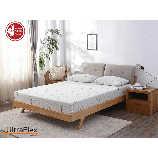 UltraFlex SolidSleep Canadian-made firm gel-infused mattress displayed on a wooden bed frame in a bright, modern bedroom. The mattress features a bamboo cover with a subtle pattern, offering cooling technology and pressure relief. CertiPUR-US® certified foam ensures safety and durability. A bedside table with a lamp and a cup is placed nearby, and a wicker chair with a cushion is visible in the background. The room is well-lit with natural light streaming through sheer curtains.