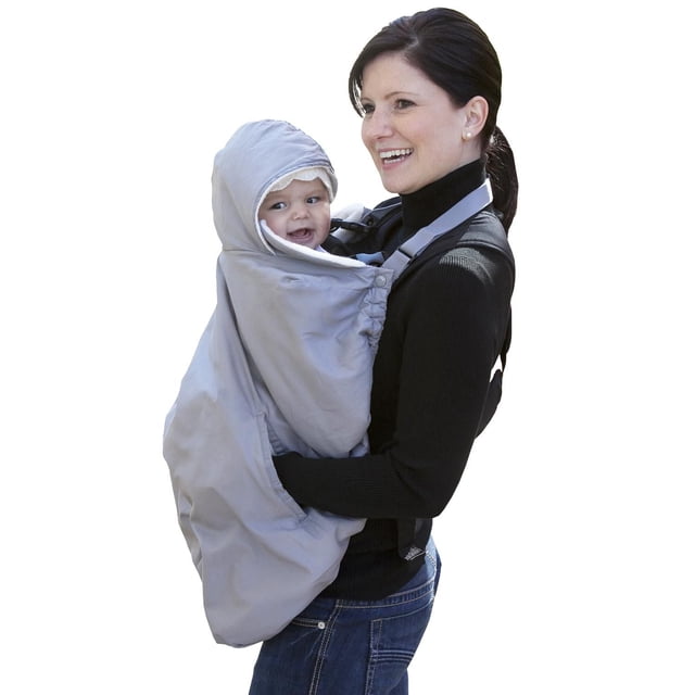 Jolly Jumper Snuggle Cover in grey, a water-repellent, fleece-lined baby carrier cover with roll-away hood, fold-over collar, and hand-warming pockets with inner slits, shown worn over a baby carrier by a person in a black sweater and blue jeans.