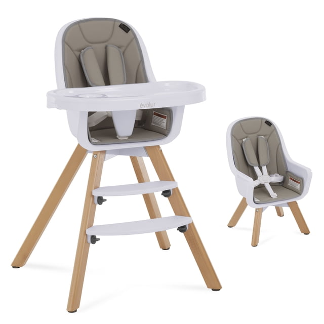 Evolur Zoodle Chaise Haute 2-en-1 avec Pattes en Bois de Hêtre et Pieds Antidérapants, Siège en PP Blanc de Qualité Alimentaire, et Housse Rembourrée Amovible en Tissu PUL Gris. Elle Présente un Plateau double Réglable à Deux Positions avec Porte-Gobelet, Harnais de Sécurité à Cinq Points avec Bretelles Rembourrées, et Deux Repose-Pieds Réglables. la Chaise Se Convertit en Chaise pour Tout-Petit avec Pattes Plus Courtes, Côte à Côte sur Fond Blanc.