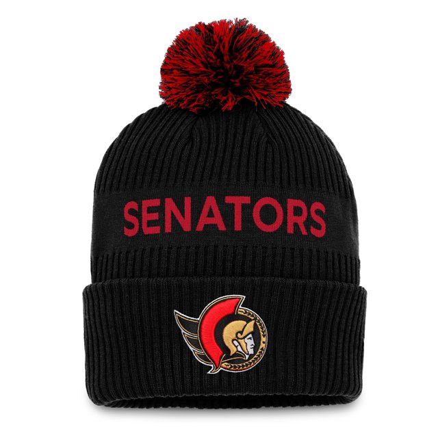 Youth Ottawa Senators NHL Authentic Pro Wordmark Pom Pom Toque featuring a black ribbed knit design with a red and black pom pom on top. The front displays the team name 'Senators' in bold red knit lettering and the Ottawa Senators logo in raised embroidery on the cuff. Made from 100% acrylic and officially licensed by the NHL.