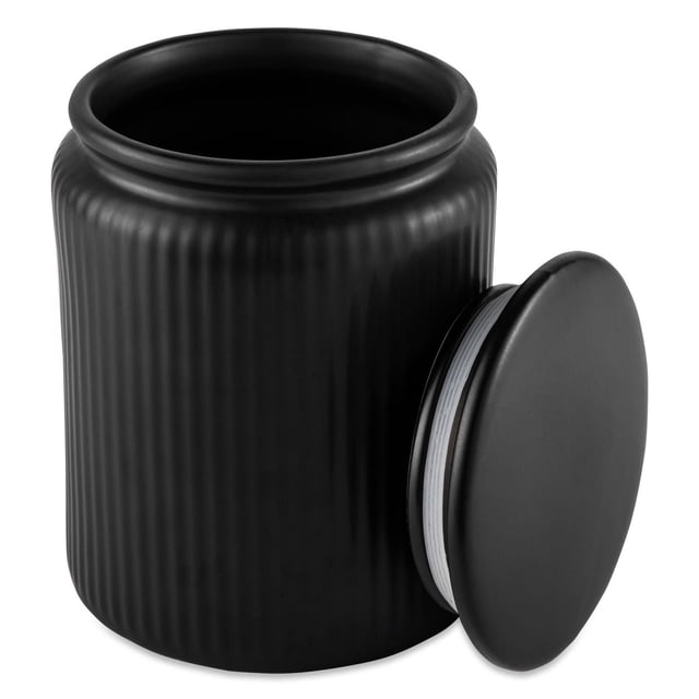 Thyme & Table Large Ceramic Ribbed Kitchen Organization Jar in black with vertical ribbed ceramic texture and a removable round lid beside it, offering 1.9-liter capacity for storing pantry essentials or snacks on kitchen counters.
