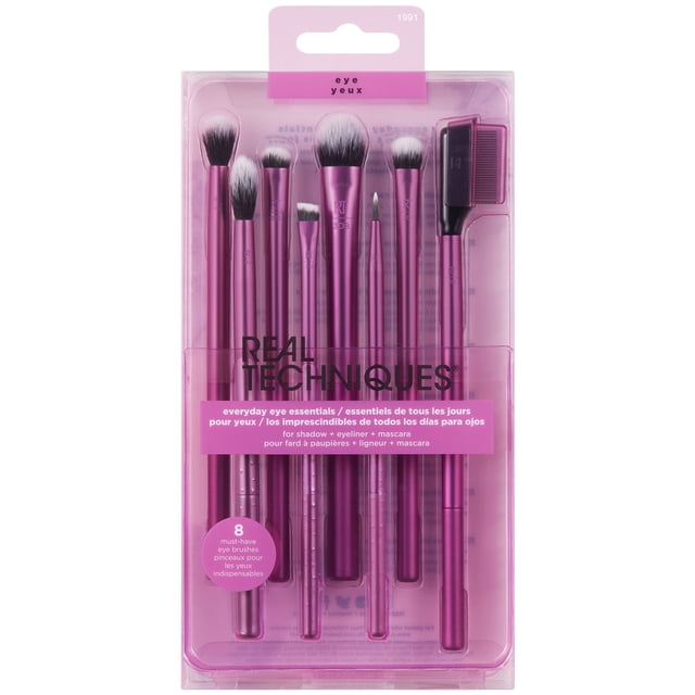 Real Techniques Everyday Eye Essentials makeup brush set with eight purple-handled synthetic brushes for eyeshadow, eyeliner, and mascara, including shading, crease, smudge, and lash separator brushes, in clear plastic packaging with brand logo and product details.