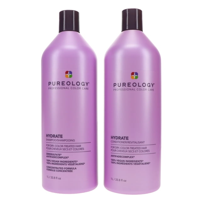 Pureology Hydrate Shampoo 33.8 oz and Hydrate Conditioner 33.8 oz combo pack. Two tall, lavender-coloured bottles with black caps, featuring the Pureology logo and text highlighting their professional color care benefits. Designed for dry, color-treated hair, the shampoo and conditioner nourish, moisturize, and protect hair while enhancing shine with ingredients like green tea, sage, and jojoba oil. Packaged in 95% post-consumer recycled materials.