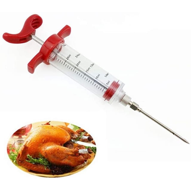 Kitchen Witch Meat Injector Kit with a clear syringe featuring red handles and measurement markings, paired with a stainless steel needle for injecting marinades and sauces into meat. A roasted turkey on a plate is shown, illustrating its use for enhancing flavour in poultry and other dishes.
