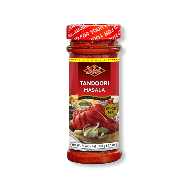 MASALA TANDOORI Desi Tandoori Masala spice mix in a clear glass jar with red screw cap, containing 100 g (3.5 oz) of red powdered spice, label features cooked tandoori chicken with sliced onions and green chutney, ideal for Indian curries, marinades, and tandoori dishes.