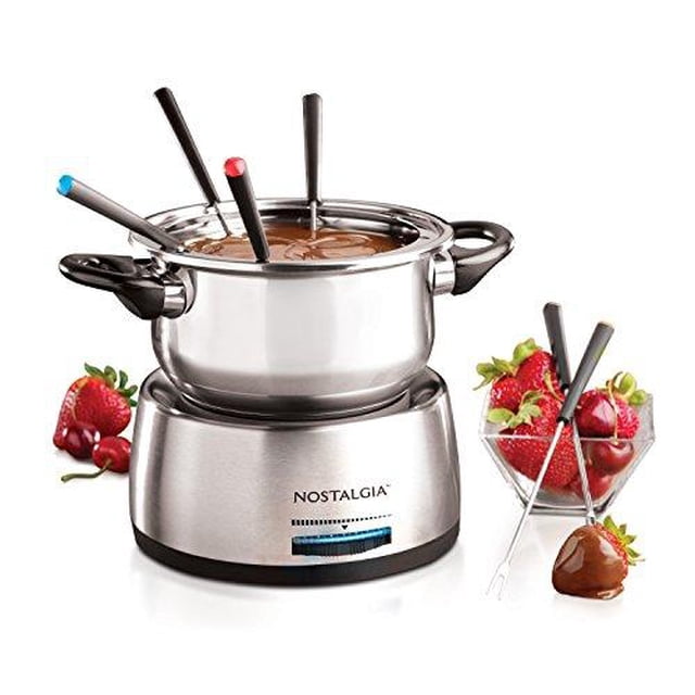 Nostalgia FPS200 Stainless Steel Electric Fondue Pot in grey with a 6-cup (1.4 liter) capacity. Features a blue-lit adjustable temperature control dial, cool-touch handles, and six color-coded forks for self-serving. Ideal for chocolate, cheese, and sauce fondue. The pot is shown with melted chocolate and strawberries nearby.