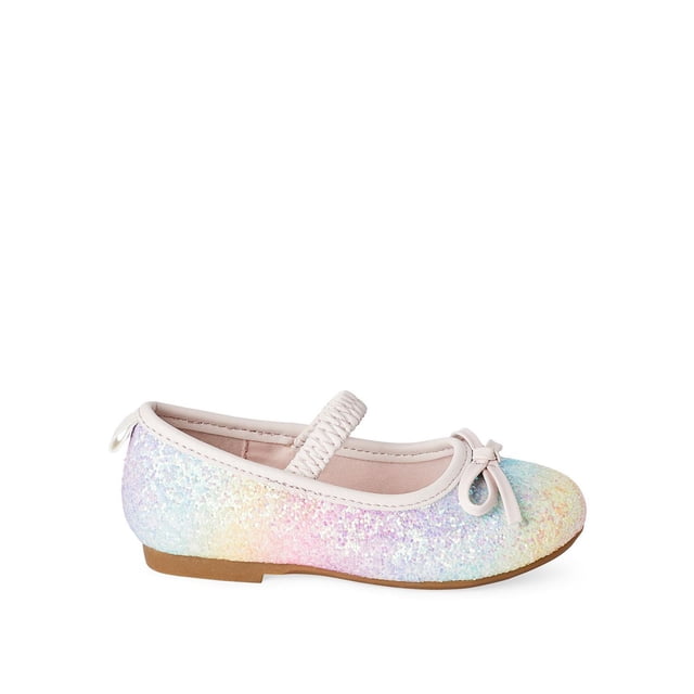 George Toddler Girls' Cora Flats in side profile with a round toe and glitter faux leather upper in pastel rainbow hues. Includes a light pink elastic strap, front bow, pull loop, and brown rubber outsole, ideal for toddler casual and special occasions.