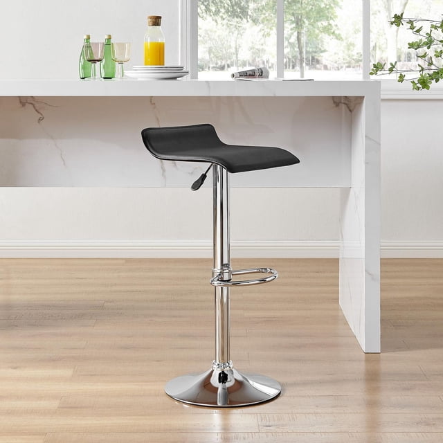 Hometrends Gaslift Swivel Barstool High Adjustable with a black PVC faux leather low-back seat on a chrome steel pedestal base, featuring a circular footrest and gas lift for height adjustment from 26 to 34.5 inches, positioned by a white marble kitchen island on light wood flooring with natural daylight, ideal for kitchen or bar seating.