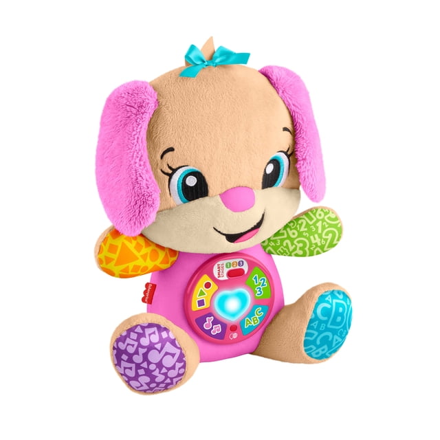 Fisher-Price Laugh & Learn Smart Stages Sis Pink Plush Baby Musical Learning Toy with a tan plush puppy featuring bright pink ears, a blue bow, multicolored patterned paws, and a pink interactive belly with a light-up heart and buttons playing 80+ songs and phrases in multiple languages, designed for infants and toddlers.
