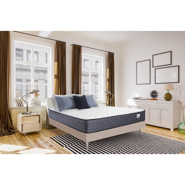 Springwall ANDREA 8" Firm Tight Top Pocket Coil Mattress in a box in a bright bedroom with large windows and brown curtains, featuring a white quilted gel foam top and dark grey quilted sides on a beige platform bed frame, accented with blue pillows and a striped black and white rug, highlighting zoned full perimeter pocket coils and firm high-density foam for targeted support.