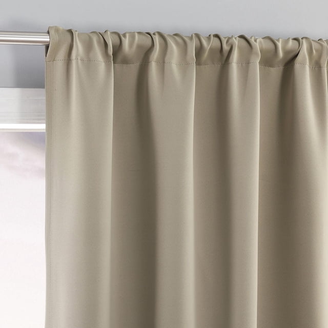 Sun Zero Laredo 2-Pack 100% Blackout Rod Pocket Window Curtains Panel Pair in beige, showing a close-up front view of one curtain panel hanging on a silver metal rod with a built-in rod pocket, made of smooth woven fabric that blocks 100% of light, reduces noise, and improves energy efficiency.