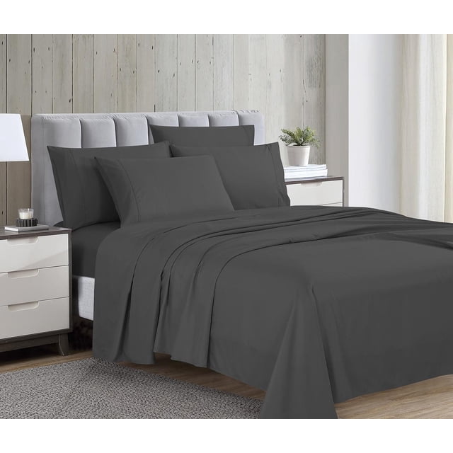1800 Series Microfiber Sheet Set with Bonus Pillowcases in grey on a bed with a light grey upholstered headboard, including flat and fitted sheets plus four pillowcases made from double brushed microfiber fabric that is wrinkle-resistant and easy care. The bedroom has wooden nightstands with a lamp, candle, and plant, light wood panel walls, and sheer curtains. The set is also suitable for guest rooms or everyday use.