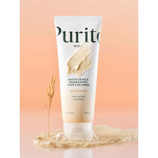 Purito Nettoyant pour le Visage Exfoliant Doux à l'Avoine 150 ml Exposé en position Debout sur un Fond Doux en Dégradé de Pêche. le tube Présente un design Propre et Minimaliste avec le Nom du Produit et des Détails sur la Clé Imprimés en Texte Vert et Noir. une Bavure de Nettoyant Crémeux Est Montrée sur le tube et Se Répand sur la surface Inférieure, Soulignant Sa texture. un Brin d'Avoine Est Placé à Côté du tube, Mettant en Valeur les Ingrédients à Base d'Avoine.