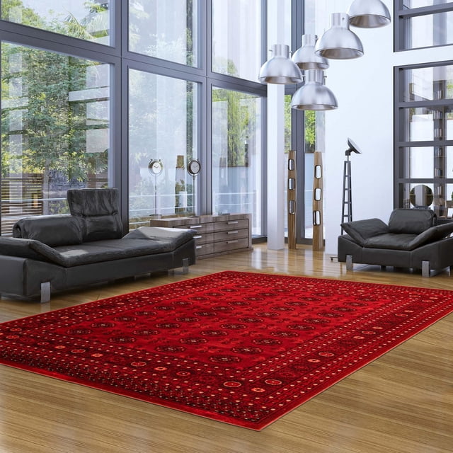 Tekke Oriental Area Rug for Living Room, Dining Room, Bedroom in a modern living room with floor-to-ceiling windows, featuring a deep red traditional pattern of symmetrical oval and diamond motifs on hardwood flooring between two black leather sofas and silver pendant lights, often used to add elegant warmth and style to living spaces.
