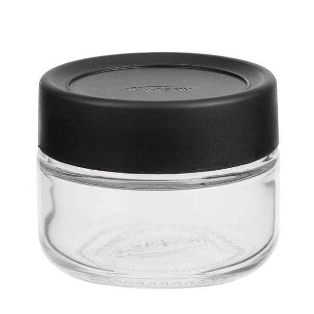 Trudeau STAK Small Spice bottle, 85ml, 1 pc, unfilled, clear glass kitchen canister with a black plastic screw-on lid embossed with the Trudeau logo, compact cylindrical shape designed for food storage and kitchen organization, ideal for stacking with other bottles.