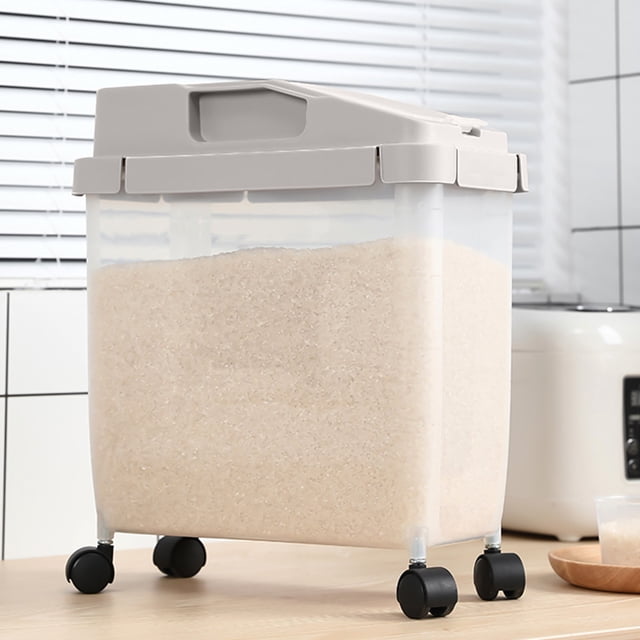 RKSTN Storage and Organization Large Airtight 20Lb Rice Container with a khaki lid and transparent body, shown filled with rice. Features four black caster wheels for portability and a visible window for monitoring contents. Includes a measuring cup and is suitable for storing rice, cereal, pet food, or other dry goods. Made of food-grade polypropylene plastic with a double-sealing ring design for freshness. Dimensions are approximately 38x28x13cm.