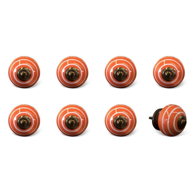 KNOB-IT vintage handpainted ceramic knobs 8 pack featuring round orange cabinet hardware with white concentric circles and antique brass center screws, arranged in two rows with one knob on its side showing the bolt, ideal for updating drawers and cupboards.