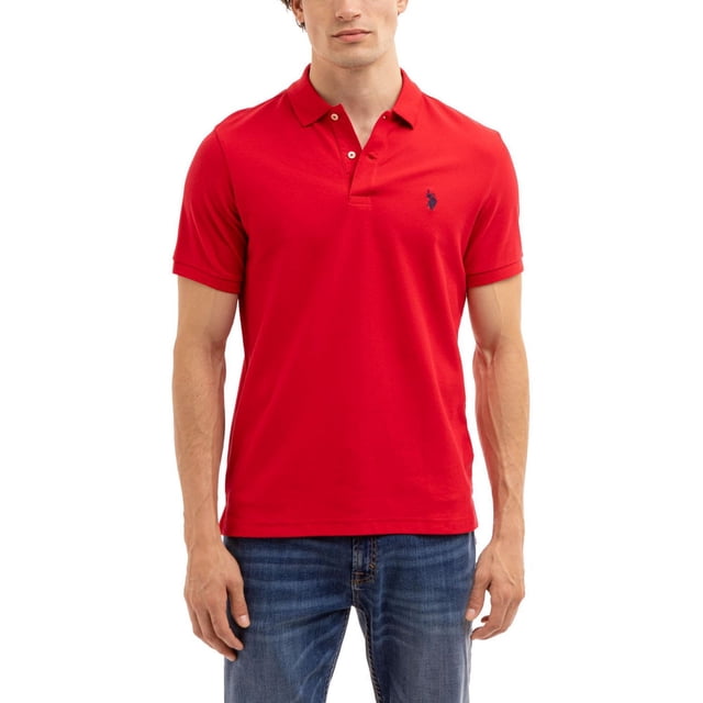 U.S. Polo Assn. Men's Performance Polo in red with short sleeves, classic collar, two-button placket, and navy embroidered logo on the left chest, shown front-facing worn with blue jeans, ideal for casual and performance wear.