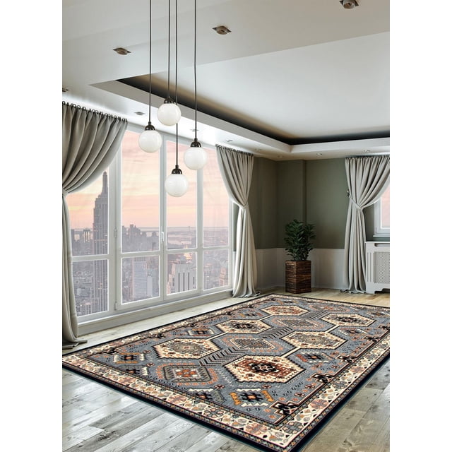 ECARPET Qashqai Aqua Rug featuring Persian tribal patterns in aqua, beige, and rust tones on a rectangular indoor area rug measuring 8 by 10 feet. It is placed on light wood flooring in a modern room with large windows showing a city skyline at sunset, beige curtains, a wooden planter with a green plant, and hanging globe pendant lights. This accent rug is also suitable for adding warmth and style to living spaces.