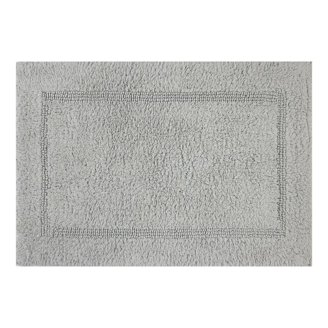 Better Homes & Gardens Cotton Reversible Bath Rug in soft silver, 17" x 24", featuring a rectangular shape with a textured border and plush absorbent cotton looped pile, machine washable and ideal for bathroom comfort and decor.