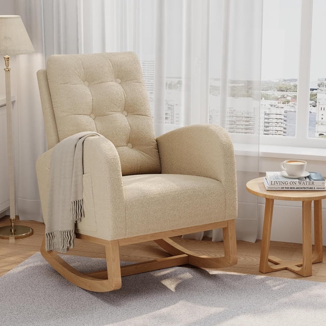 Twister.CK Modern Rocking Accent Chair, upholstered in light brown fabric with a tufted backrest, rounded armrests, and a durable hardwood rocking base. Designed for ergonomic support, it features side pockets for storage and is ideal for nurseries, living rooms, or bedrooms. Displayed in a bright living room with a side table and decor elements.