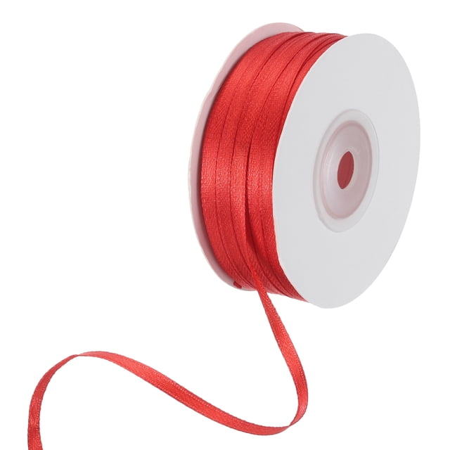 Unique Bargains Satin Ribbon, 1/8 Inch x 100 Yards Red Double Face Polyester Satin Ribbon for Gift Wrapping, Bouquet. A roll of red satin ribbon with a smooth, shiny surface, measuring 1/8 inch wide and 100 yards long. The ribbon is wound on a white spool, suitable for crafts, gift wrapping, floral designs, and holiday decorations.