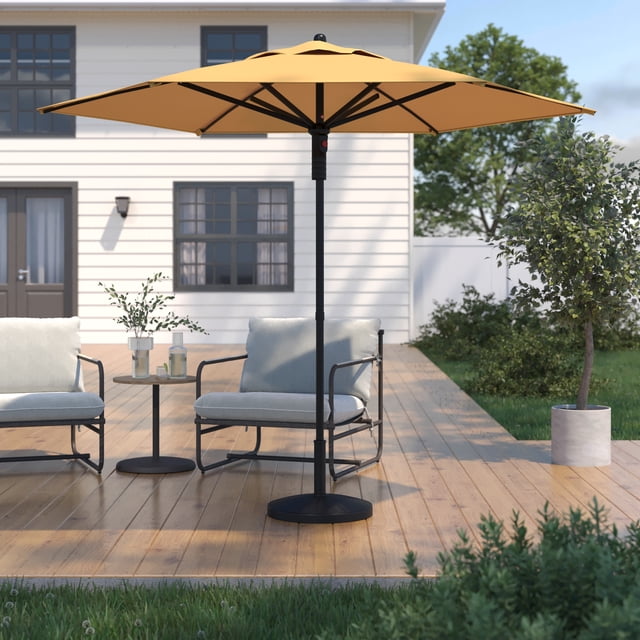 HOMETRENDS 7.5 ft. Round Push-Up Market Patio Umbrella in yolk yellow with rust-resistant powder-coated steel frame and wind vent, providing 30 sq. ft. of shade on a wooden deck between two cushioned metal chairs and a small table outside a white house with greenery.