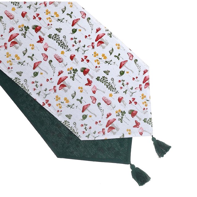 Cotton Table Runner 54" Mushroom made of white cotton fabric with a multicolored mushroom and floral pattern in red, yellow, and green, featuring dark green tassels on each pointed end, designed to protect and enhance dining tables with a breathable, boho style.