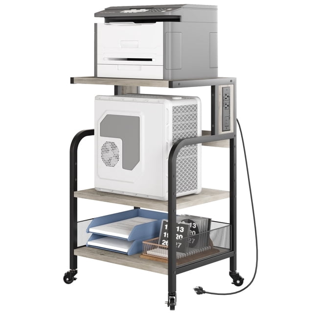 Portable Printer Stand with Power Outlet, a 3-tier rolling printer table designed for office furniture use. Features adjustable storage shelves, a built-in charging station with 2 AC outlets and 2 USB ports, and a sturdy grey MDF board construction with a black metal frame. The top shelf accommodates a printer, while the middle and bottom shelves provide space for office equipment and supplies. Includes adjustable feet and rolling casters for stability and mobility.