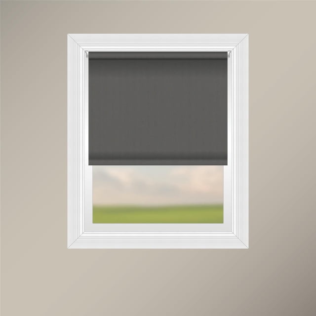 Off Cut Shades Chainless Blackout Roller Shade in black polyester fabric installed on a white window frame with beige wall, featuring a smooth, light-blocking roller blind with sewn hem and weighted insert for a clean finish, ideal for bedrooms and glare reduction.