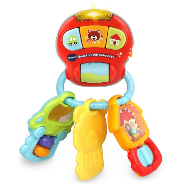 VTech Smart Sounds Baby Keys™ multicolour interactive baby toy with a red main unit featuring three colorful buttons showing a car, bear, and house, connected to a blue ring holding three textured keys in green, yellow, and orange with rattles and a bear-shaped teether, designed to develop fine motor skills and introduce cause and effect through sounds and lights.
