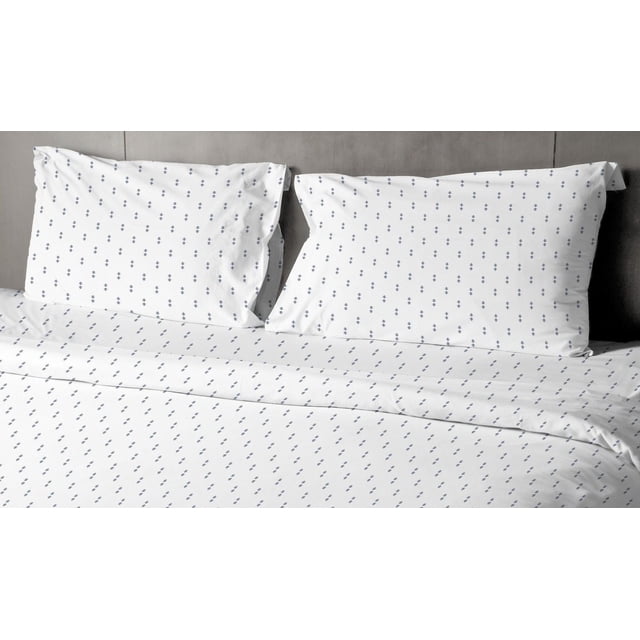 Johnson Home 200 TC Bed Sheet Set - Printed Cotton Sheets in white with a small navy blue floral pattern, including two pillowcases and a flat sheet on a bed with a grey upholstered headboard, made from breathable 200 thread count cotton for softness and year-round comfort.