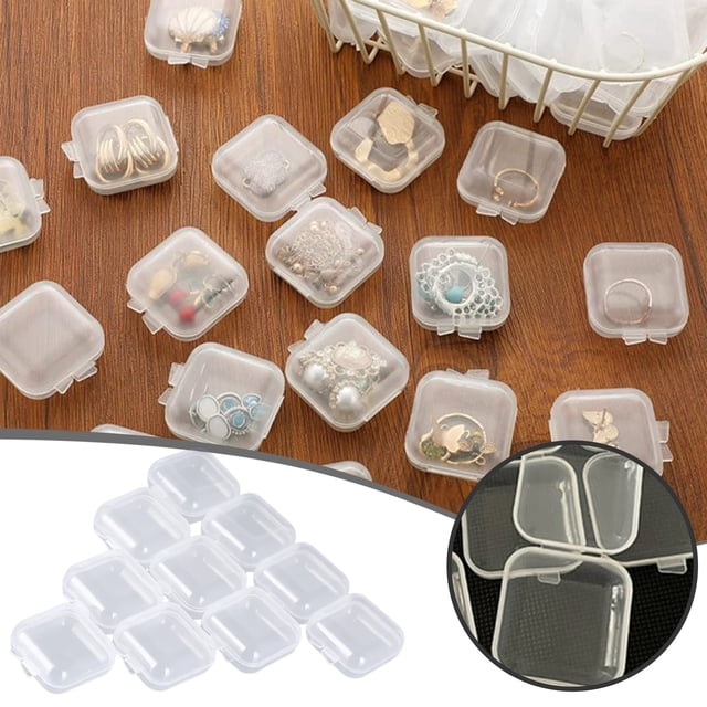 WIFKLSIIPG 50 Pack Small Clear Beads Storage Containers with hinged lids, measuring 1.37 x 1.37 x 0.78 inches, designed for organizing small items like jewelry, crafts, and hardware. The transparent PP material allows easy visibility of contents. Shown scattered on a wooden surface with various items stored inside, including rings and beads, alongside a basket holding additional containers.