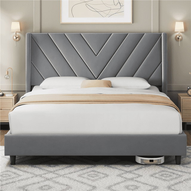 Fullfurnique Upholstered Platform Bed Frame with Wooden Slat Support, Queen, Light Gray, front-facing view showing a wingback headboard with symmetrical geometric stitching in velvet fabric, supported by 12 solid wood slats and reinforced legs for mattress support without box spring, set in a modern bedroom with wooden nightstands, wall sconces, and a patterned rug, ideal as a durable and stylish bedroom centerpiece.