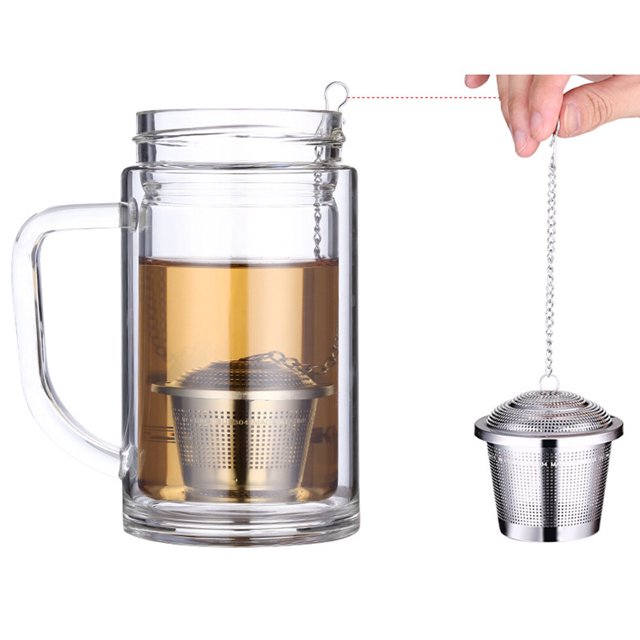 IFANLANDOR Metal Tea Strainer for Herbal Tea Infusing and Kitchen Use, shown in a stainless steel design with a fine mesh filter. The strainer is displayed in use, steeping loose leaf tea in a clear glass mug. A chain with a hook allows for easy removal. Ideal for single-serve tea preparation, it features a flat-bottomed square shape for stability and is dishwasher safe for easy cleaning.