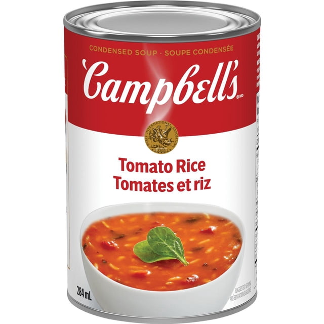 Campbell's® Condensed Tomato Rice Soup, Shelf Stable can with red and white label featuring the Campbell's logo and bilingual text 'Tomato Rice / Tomates et riz.' The label shows a bowl of tomato rice soup garnished with a green leaf, 284 mL volume. This vegetarian soup contains farm-grown tomatoes and long grain rice, with no artificial flavours and a non-BPA lining, suitable for quick pantry meals.