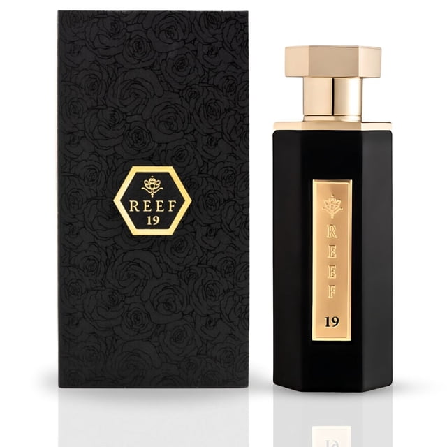 Reef 19 - EDP Spray 100ML (3.38 OZ) by Reef Perfumes, a luxurious and long-lasting fragrance for women. The perfume features top notes of Lily of the Valley, middle notes of jasmine, and a base of white musk, creating a fresh, floral, and velvety scent. The image shows a sleek black bottle with gold accents and a matching black box adorned with a subtle rose pattern, emphasizing elegance and sophistication. Suitable for all occasions.