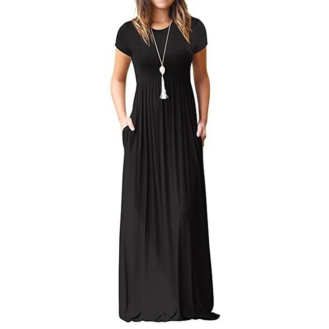 Robe Décontractée Ample et Confortable pour Femme de Couleur Noire Unie. Cette Robe maxi à Manches Courtes Présente une Coupe Décontractée, un design Longueur Genou et des Poches Latérales Fonctionnelles. Convient pour l'Été et Offerte en Tailles P à 5TG. Présentée avec un long Collier à Pampilles.