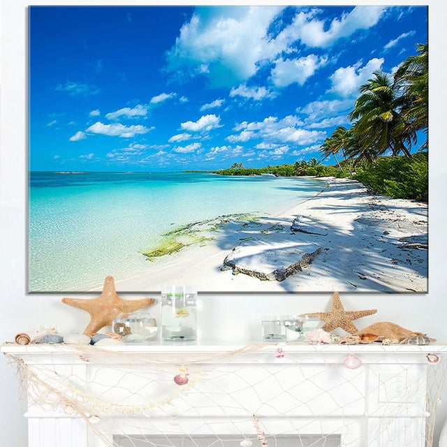 Design Art Tropical Beach with Palm Shadows Large Seashore Canvas Art Print, a 40 by 30 inch gallery-wrapped cotton canvas featuring a tropical beach with turquoise water, white sand, palm tree shadows, and blue sky with clouds, ready to hang with included hardware, suitable for enhancing home or office wall décor.