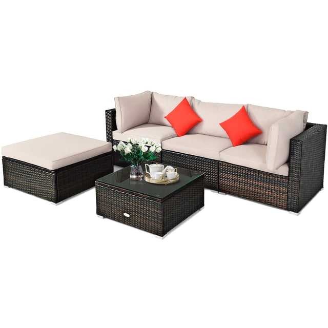 Patiojoy 5-Piece Outdoor Patio Sectional Rattan Sofa Set with a brown PE rattan frame, beige cushions, and two red accent pillows. Includes two corner sofas, one armless sofa, one ottoman, and a coffee table with a glass top. Ideal for outdoor patio furniture setups, featuring waterproof and fade-resistant materials for durability.