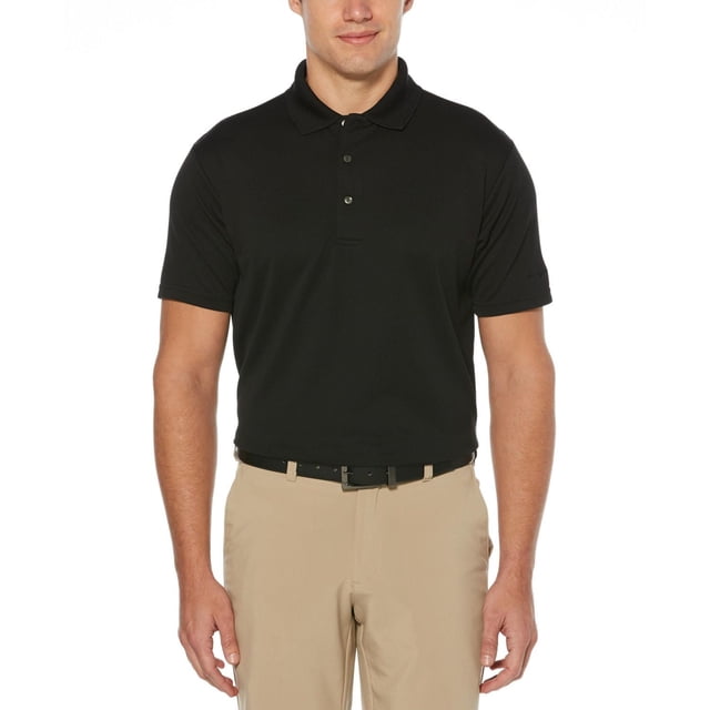 Men's Performance Easy Care Solid Short Sleeve Polo Shirt in black, front view on a male model wearing beige trousers and a black belt, featuring moisture-wicking fabric, sun protection technology, and stretch seams for comfort and mobility, suitable for golf and casual wear.