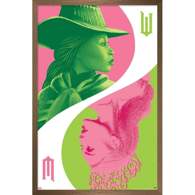 Wicked - Reflection Wall Poster with Push Pins, 22.375" x 34" featuring stylized graphic art of two female profiles in green and pink, one wearing a wide-brimmed hat and the other a crown, separated by a white curved line on a split pink and green background, framed in wood, suitable for bedroom or office wall décor.