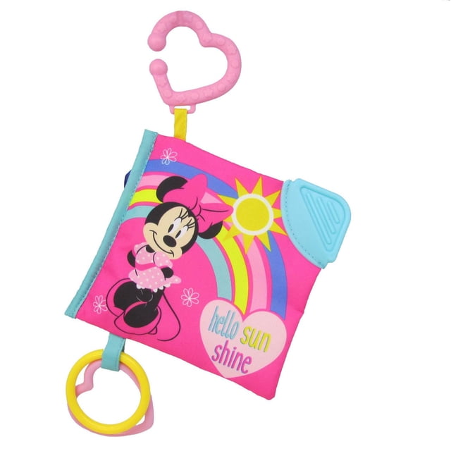 Disney Minnie Mouse Livre Doux avec une Couverture en Tissu Rose Mettant en Vedette Minnie Mouse en Robe à Pois Roses et Nœud, un Soleil Jaune et un Arc-en-Ciel. Comprend un Coin de Dentition Bleu, une Pince Rose en Forme de Cœur pour l'Accessoire de Poussette, et un Anneau Jaune et Rose. Conçu pour le Développement Sensoriel des Nourrissons et le Soulagement de la Dentition.