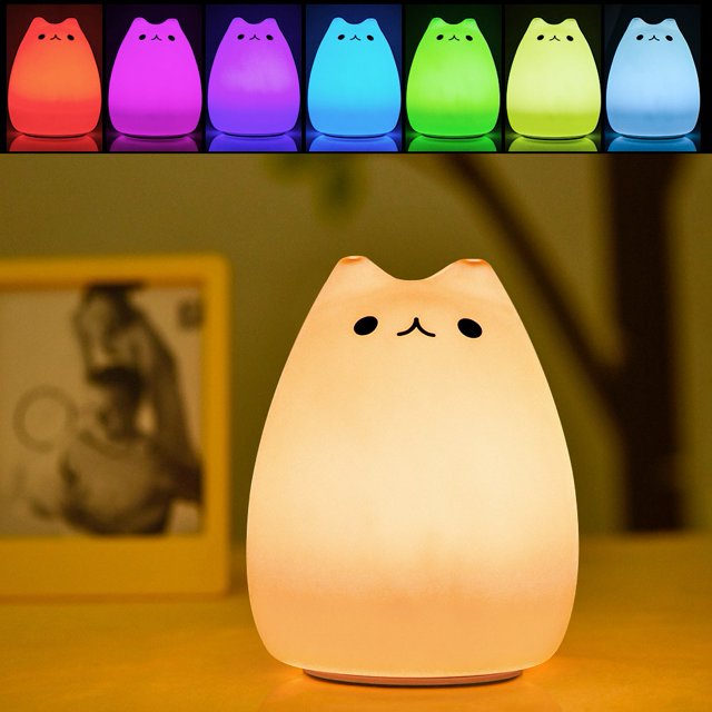 Spptty Children Night Light, a cute cat-shaped lamp made of soft silicone with sensitive tap control. The lamp features a multicolour LED light with 7 colour options, making it ideal for nurseries, kids' rooms, or as a decorative piece. It is USB rechargeable with a 1200mAh lithium battery, providing 12-15 hours of use after a 3-4 hour charge. The lamp measures 14 x 10 x 11 cm and weighs 208 g. Includes a USB cable and an English manual.